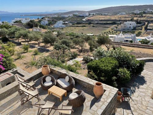 a view of a patio with chairs and a table at villa ZEUS - PARIKIA - PAROS - GRECE in Krotiri