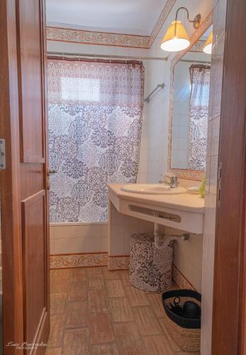 a bathroom with a sink and a shower at Cozy Pool House in Carvoeiro
