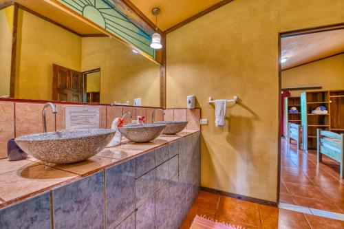 a bathroom with two sinks on a counter at The Goddess Garden Eco-Resort in Cahuita