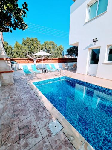 a swimming pool in front of a house at Villa Alkioni 31 in Paralimni