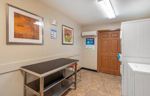 a room with a table and a refrigerator at Extended Stay America Suites - Norfolk - Virginia Beach in Virginia Beach