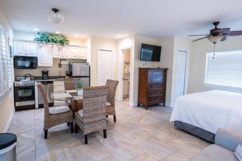 a kitchen and a bedroom with a table and chairs at The Capri at Siesta in Siesta Key