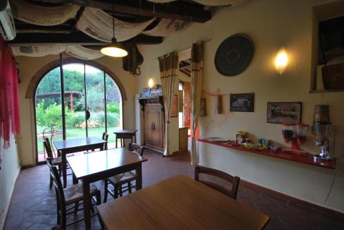 a kitchen and dining room with tables and chairs at San Martin del Colle Holiday Home in Casciana Terme
