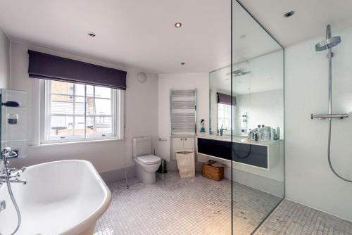 a bathroom with a sink and a toilet and a shower at Stunning 3 Bed Townhouse in the heart of Mayfair in London