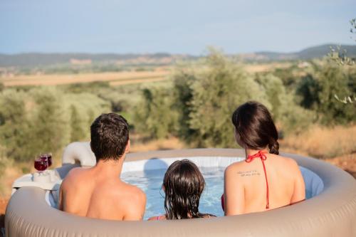 a group of three people sitting in an inflatable pool at Agriturismo I Grappoli in Alberese