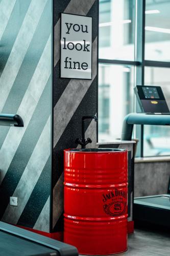 a red barrel sitting next to a desk with a sign at Hills Resort Hotel in Yerevan
