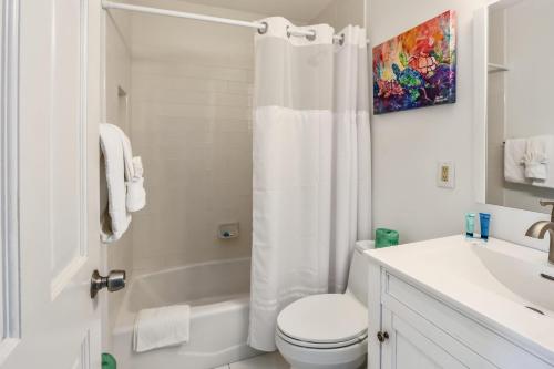 a bathroom with a shower and a toilet and a sink at Sunset Villas 3 in Clearwater Beach