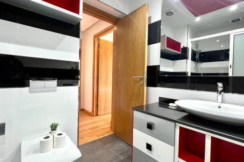 a bathroom with a sink and a mirror at The Panorama of Marina - AppartAli in Casablanca