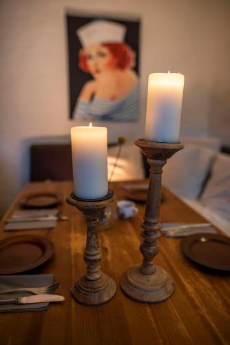 two candles sitting on top of a wooden table at Pension Haus Magarethe am Meer Poel in Insel Poel