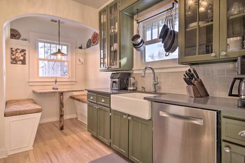 a kitchen with green cabinets and a sink at Convenient Denver Home with Private Hot Tub! in Denver
