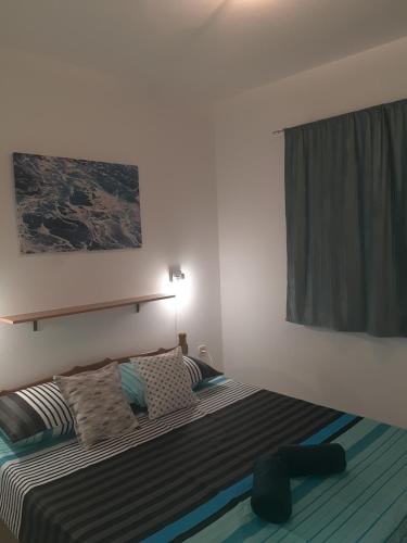 a bedroom with a bed and a window at grabrova cove in Novi Vinodolski