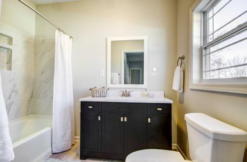 a bathroom with a sink and a toilet and a tub at Warrensburg Home, Close to Downtown! in Warrensburg