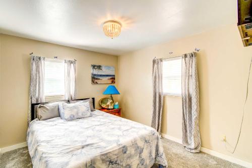 a bedroom with a bed and two windows at Beautiful Palatka Vacation Rental with Yard! in Palatka
