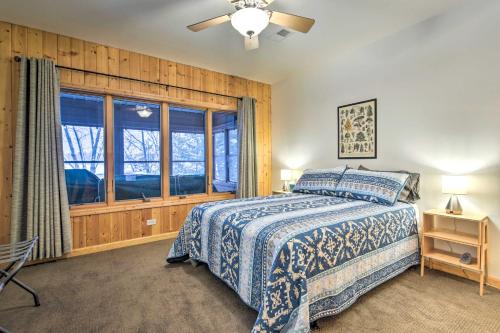 a bedroom with a bed and a window at Crandon Cabin Getaway with Boat Dock and Deck! in Crandon