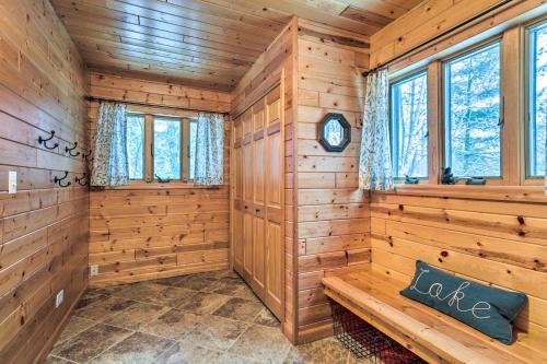 a log cabin with a bench in a room with windows at Crandon Cabin Getaway with Boat Dock and Deck! in Crandon