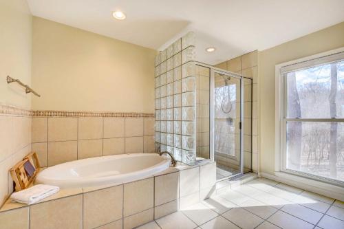 a large bathroom with a tub and a window at Louisville Area Home Deck, Fire Pit, Creek! in Prospect