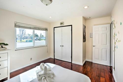 a bedroom with a bed and a large window at Sunny Santa Ana Rental Home Near Disneyland! in Santa Ana