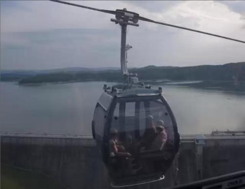 a cable car with people on it flying over a bridge at Krystyna in Bystre