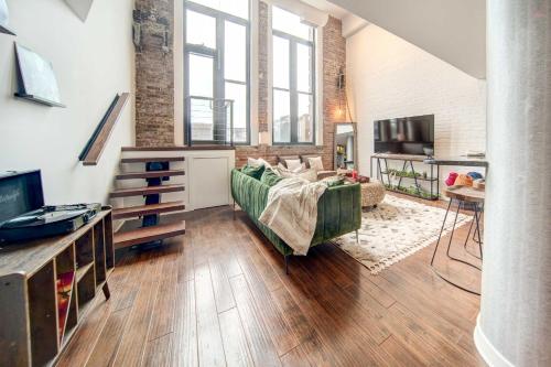 a large living room with a couch and a tv at Waterfront Cleveland Apt about 1 Mi to Downtown in Cleveland