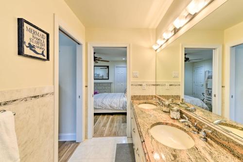 a bathroom with two sinks and a large mirror at Sunny Brigantine Townhome Walk to Beach in Brigantine
