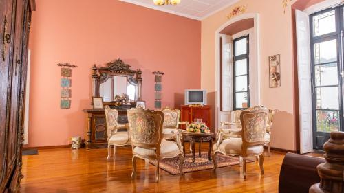 ein Esszimmer mit einem Tisch, Stühlen und einem Spiegel in der Unterkunft Casa Colonial Quito in Quito