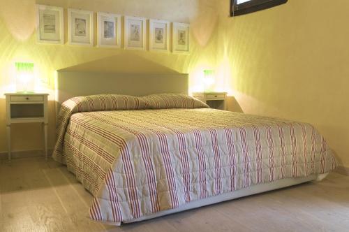 a bedroom with a bed with two nightstands and two lamps at B&B Corte delle Muse in San Felice del Benaco