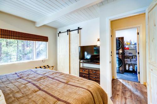 a bedroom with a bed and a flat screen tv at California Cabin Rental - Hike, Ski, Boat! in Long Barn
