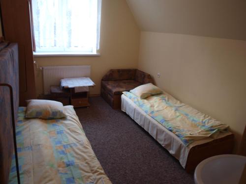 En eller flere senge i et værelse på Pokoje Gościnne Żak