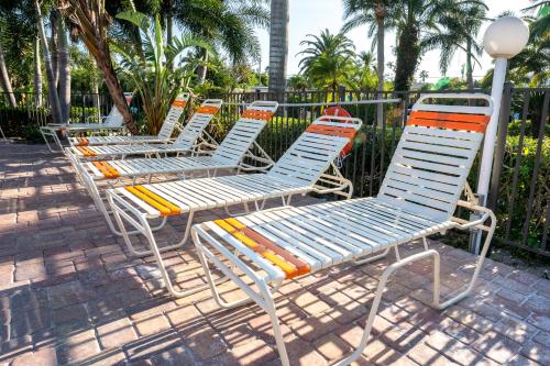 a row of chairs sitting next to a fence at The Capri at Siesta in Siesta Key