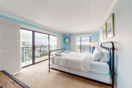 a bedroom with a bed in a room with a balcony at Summer Beach 508 in Ocean City