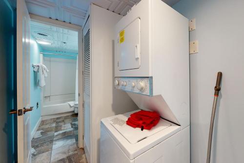 a small bathroom with white cabinets and a red towel at Summer Beach 508 in Ocean City