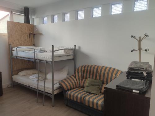 a living room with a couch and bunk beds at Bilbao Central Rooms in Bilbao