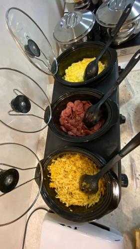 a group of three bowls of food on a stove at Pousada Águas de Maragogi in Maragogi