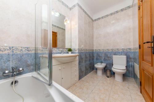 a bathroom with a tub and a sink and a toilet at B79 - Casa Gama Avenue in Lagos in Lagos