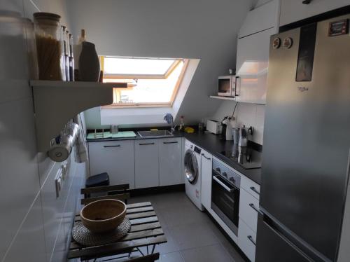 a kitchen with a washer and dryer in it at Ático nuevo en Arteixo con plaza de garaje in Arteixo