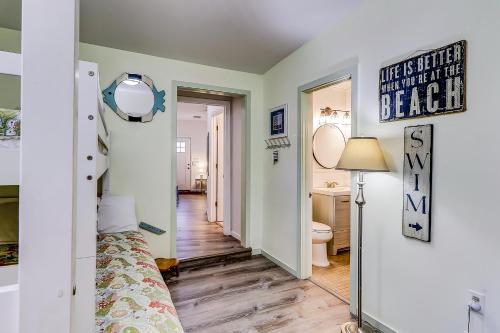 a room with a bed and a hallway with a bathroom at Moonshell 3 in Hilton Head Island