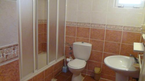 a bathroom with a toilet and a sink at Seaside Villas Rental in Çeşme