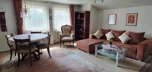 a living room with a couch and a table at Haus Bethania Ferienwohnung grande plus in Bad Kissingen