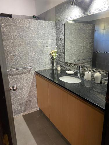 a bathroom with a sink and a mirror at Las Cholas in La Paloma