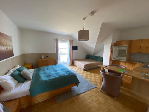 a bedroom with a bed and a desk in it at Pension Rucksackpeter in Hohenbrugg an der Raab