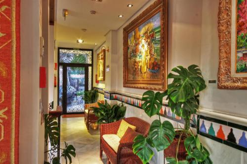 a lobby with a couch and a painting on the wall at Hotel Mirador Arabeluj in Granada