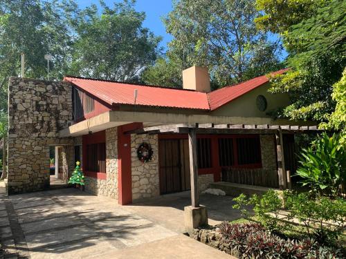 a small house with a red roof at Cabañas Maya Rue in Palenque