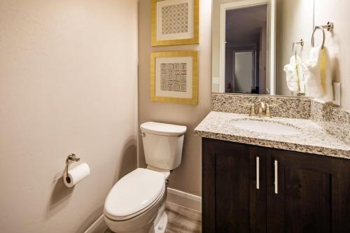 a bathroom with a toilet and a sink at Paradise Village 107 Private Pool, Hot Tub, Pickle-ball, Basketball, Futsal Court, and Game Room in Santa Clara