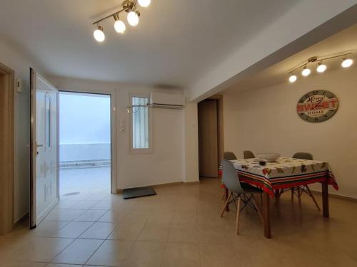 a dining room with a table and a view of the ocean at Kostas' House in Piraeus