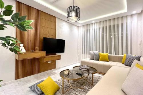 a living room with a couch and a tv at The Suite of Artists - Central - By AppartAli in Casablanca