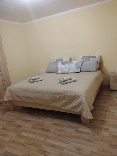 a bedroom with a bed with two books on it at Apartmaji Maki in Bled