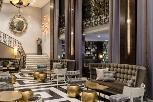 a restaurant with a couch and tables and chairs at The Empire Hotel New York in New York