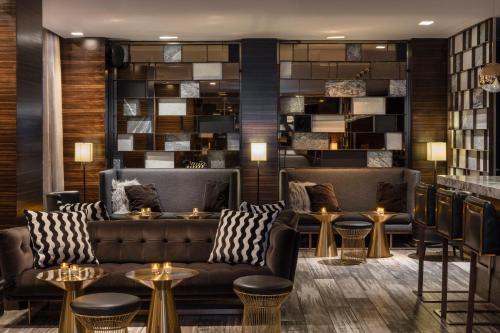 a lobby with couches and tables and a bar at The Empire Hotel New York in New York