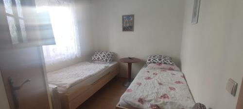 a small bedroom with a twin bed and a window at Domek nad wodospadem in Zakopane