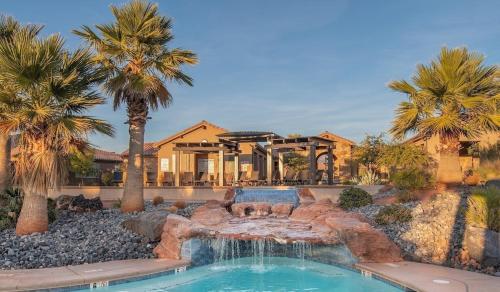 a swimming pool with a fountain in a yard with palm trees at Paradise Village 121 Private Hot Tub, X BOX, 5 Bikes, Bag Toss, Pack n' Play, Games, Mountain Views, and More in Santa Clara